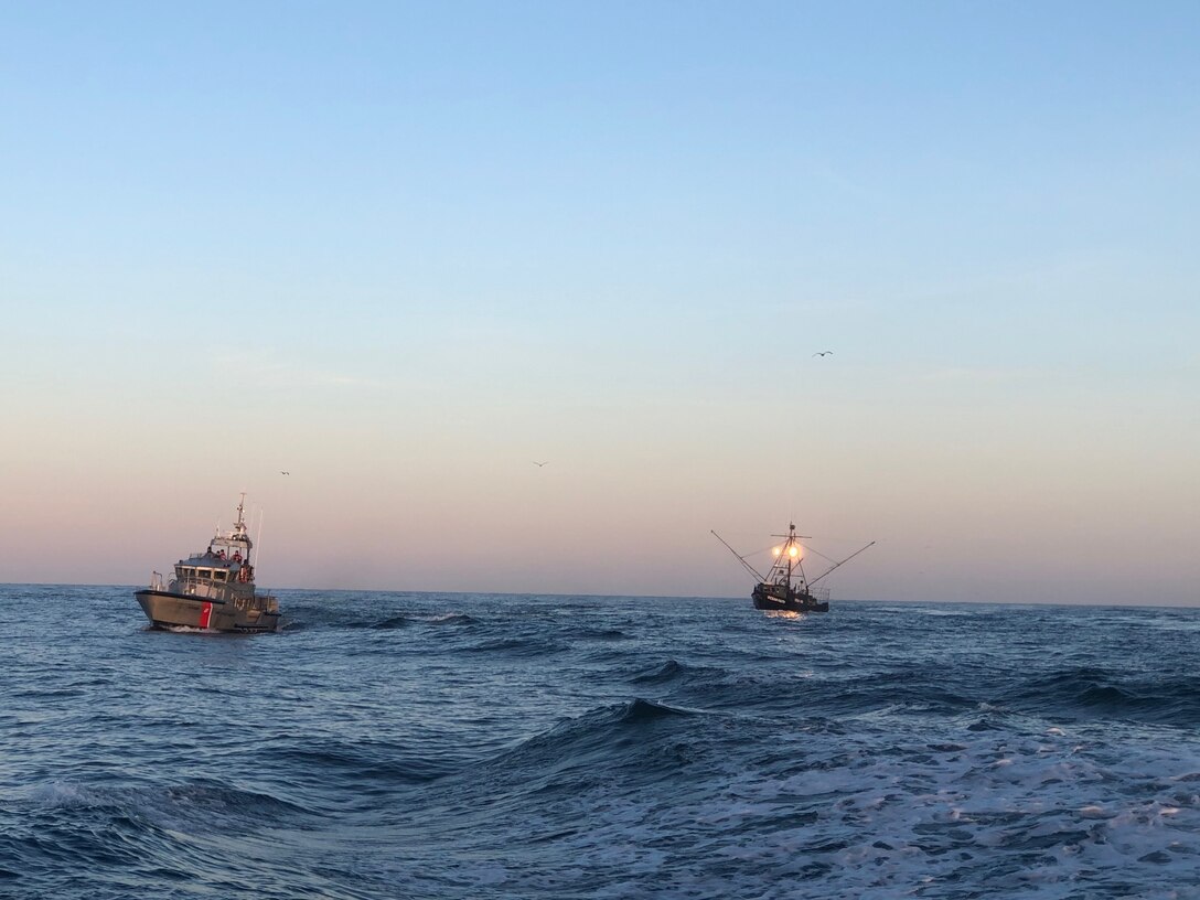 A Coast Guard crew aboard a 47-foot Motor Lifeboat tow the 61-foot commercial fishing vessel Pacific Faith