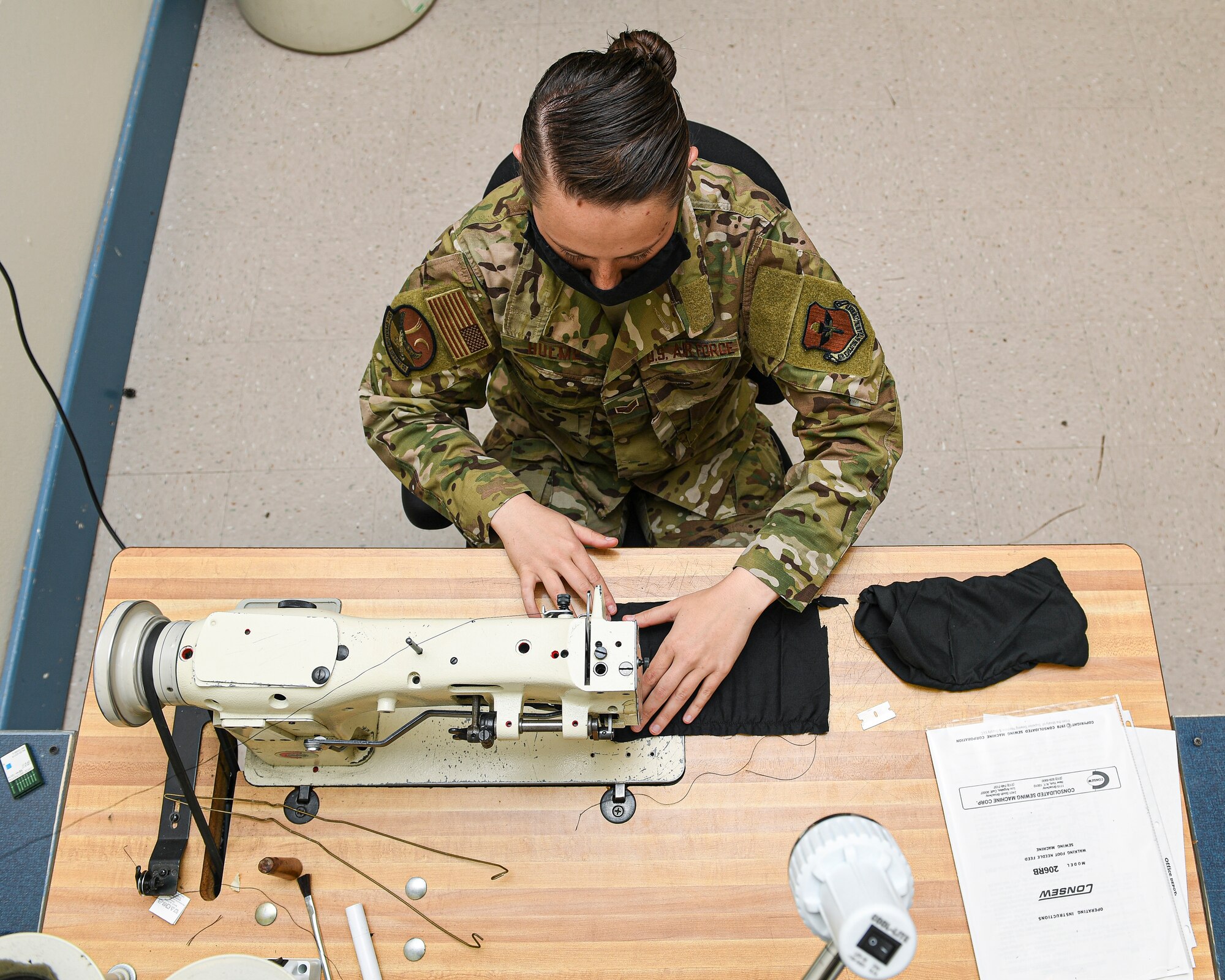photo of Airman working on a sewing machine