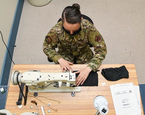 photo of Airman working on a sewing machine