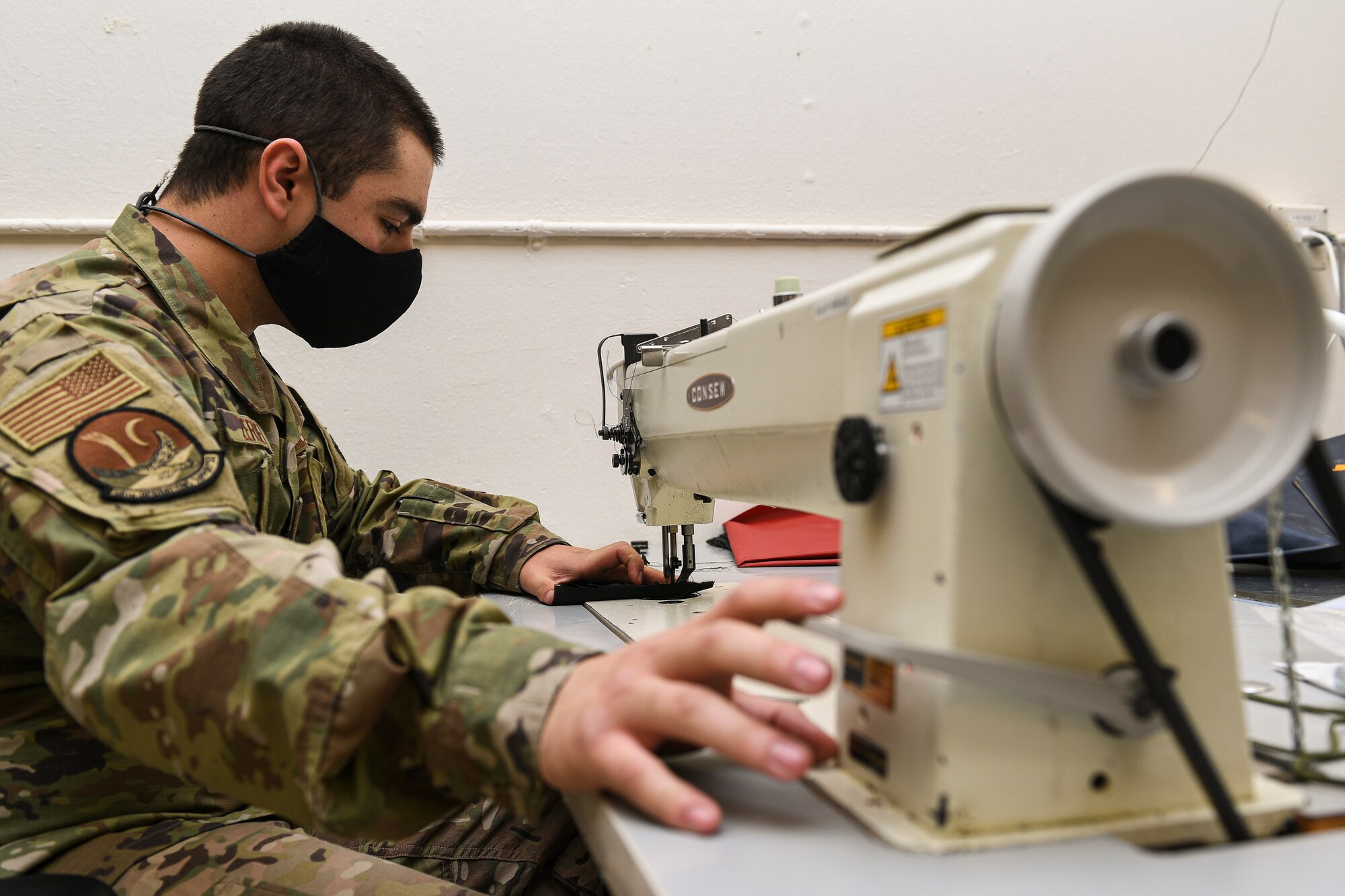 Airman at a sewing machine