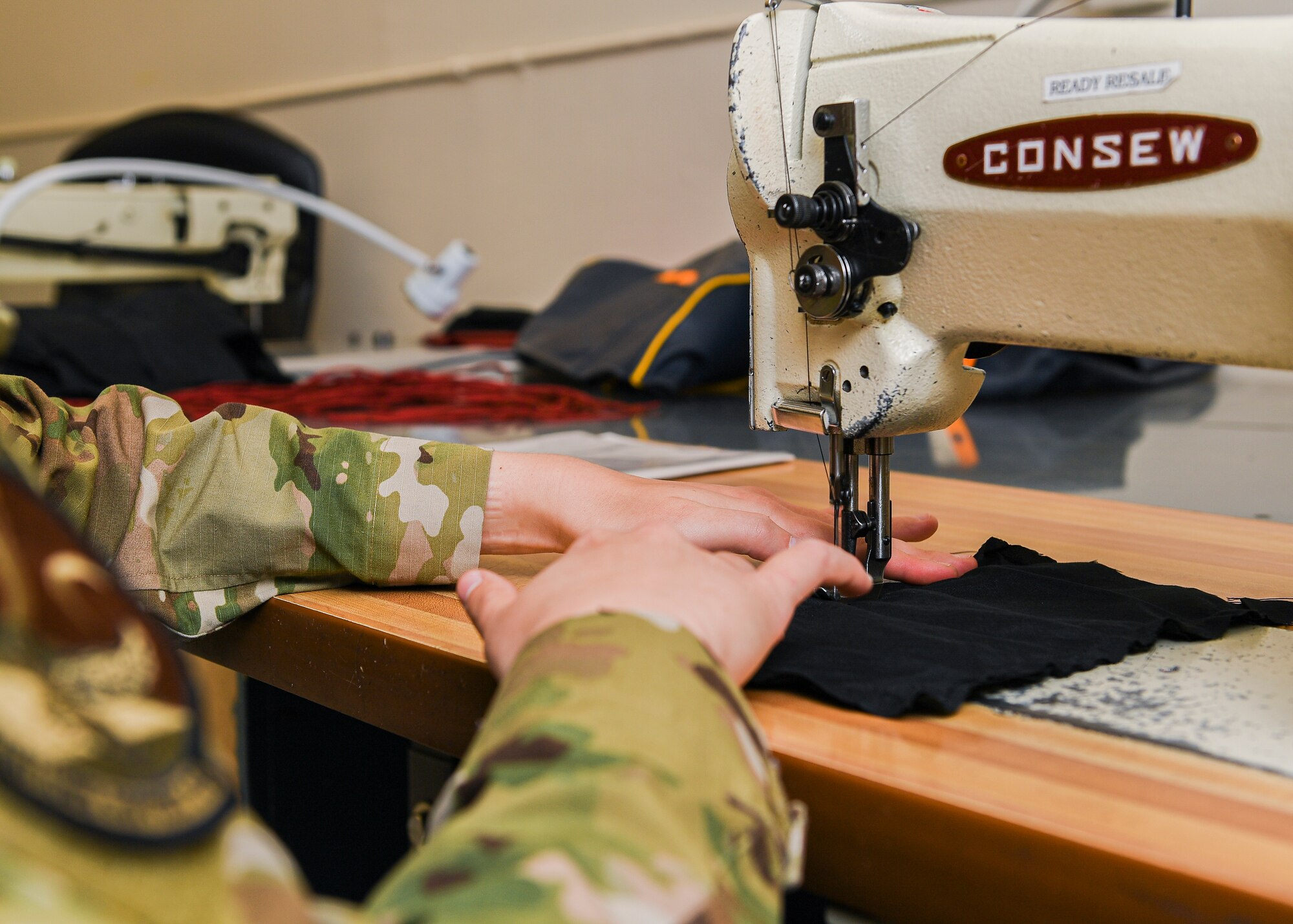 hands of an Airman at a sewing machine