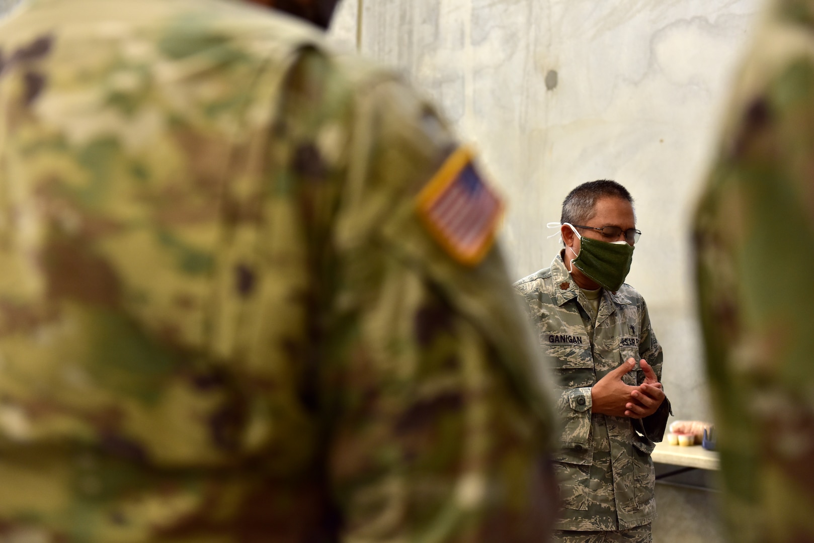 U.S. Air Force Maj. Edward Ganigan, center, a chaplain from the 163d Attack Wing, California Air National Guard, prays for soldiers of the California Army National Guard’s 315th Vertical Construction Company and staff members of the FIND Desert Regional Food Bank in Indio, California, April 29, 2020.