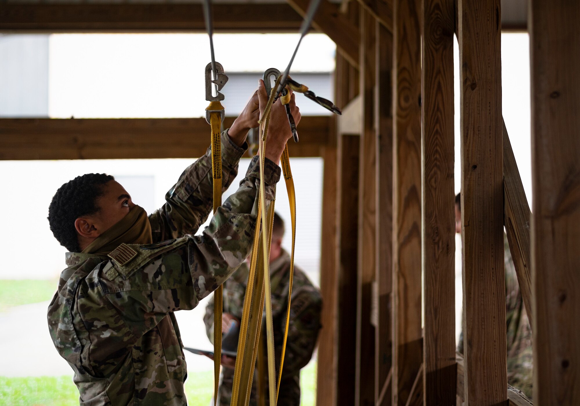 A photo of an Airman preparing for a static-line jump rehearsal