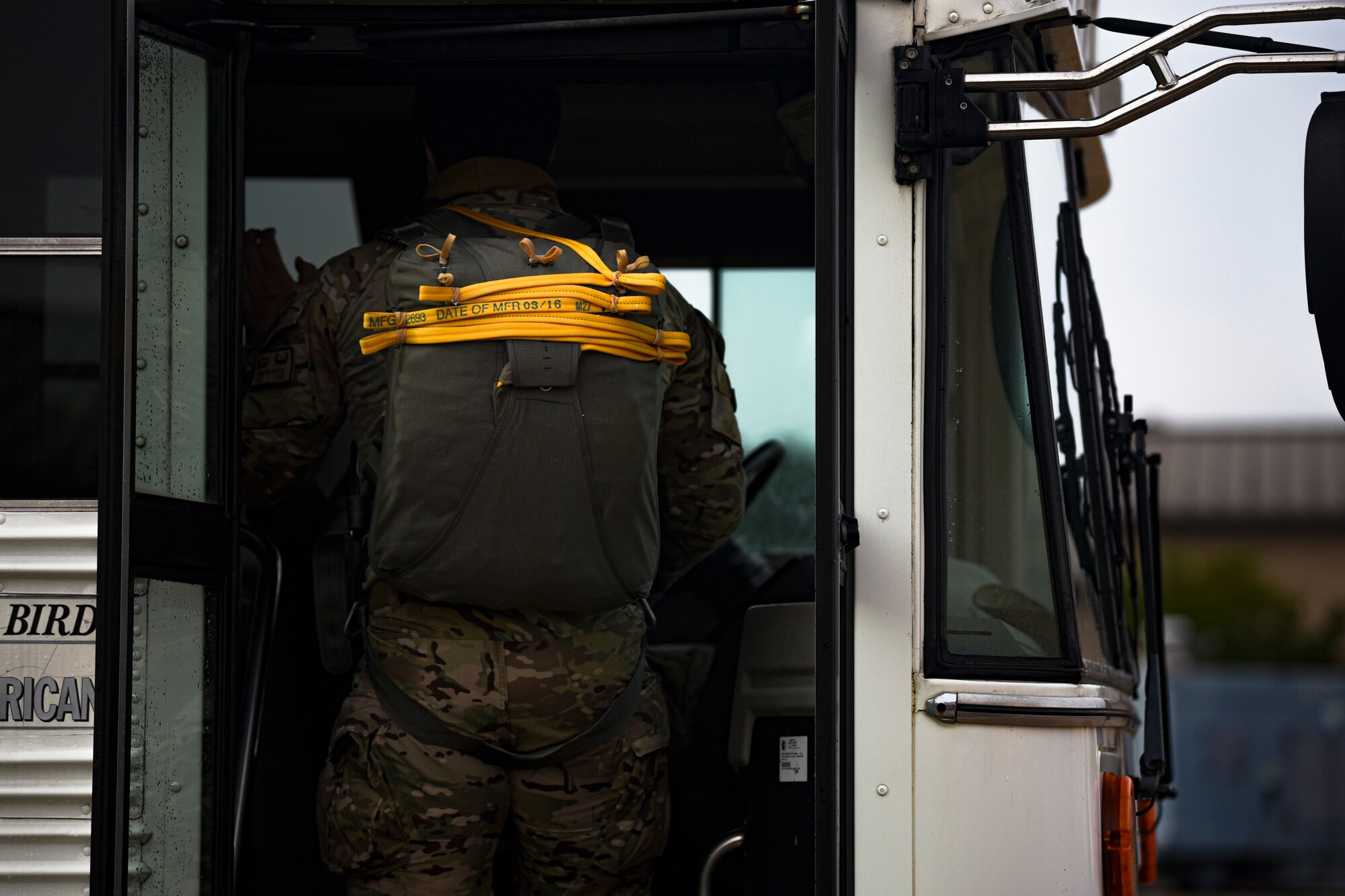 A photo of an Airman getting on a bus