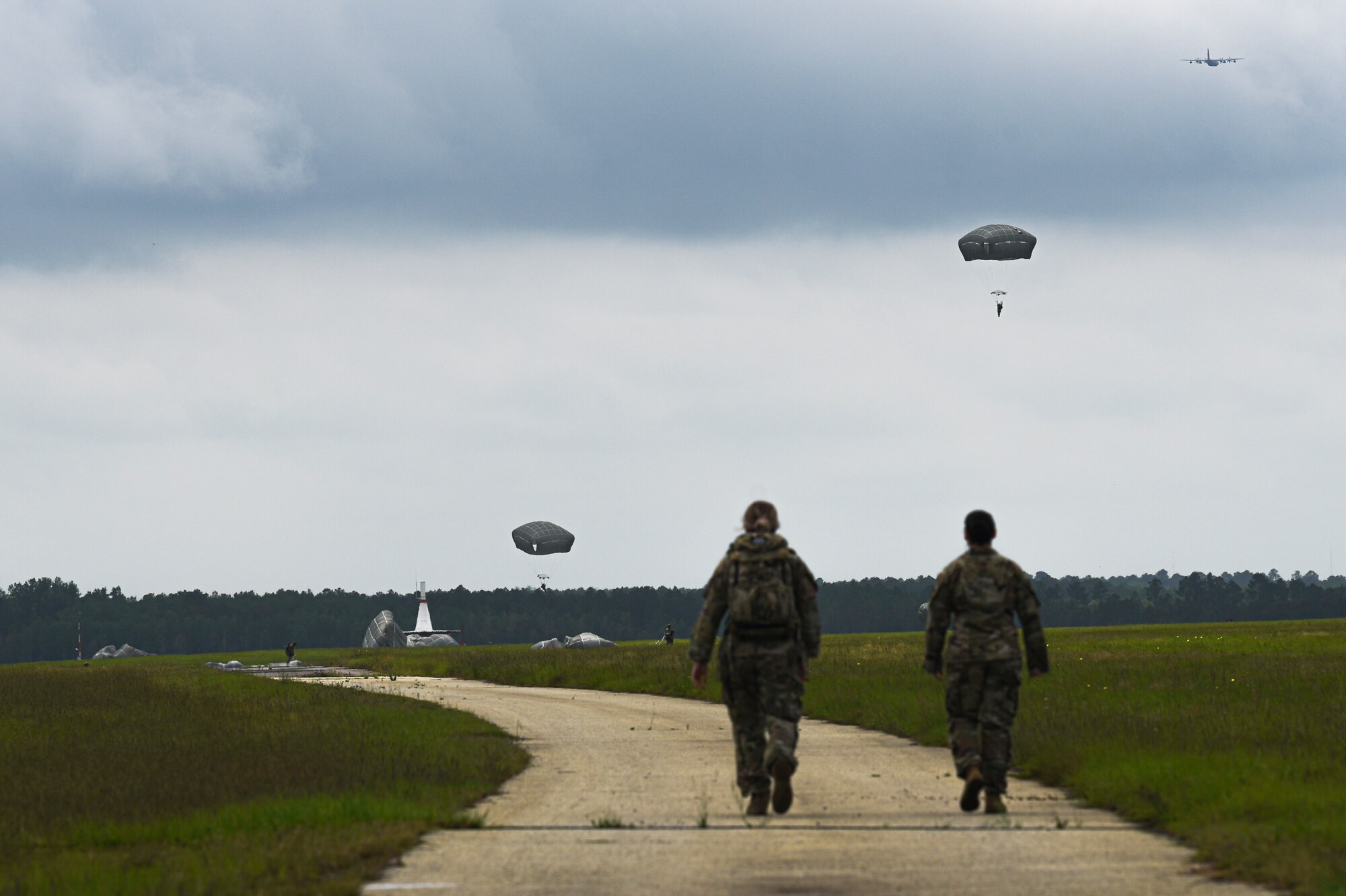 A photo of Airmen walking to parachutists