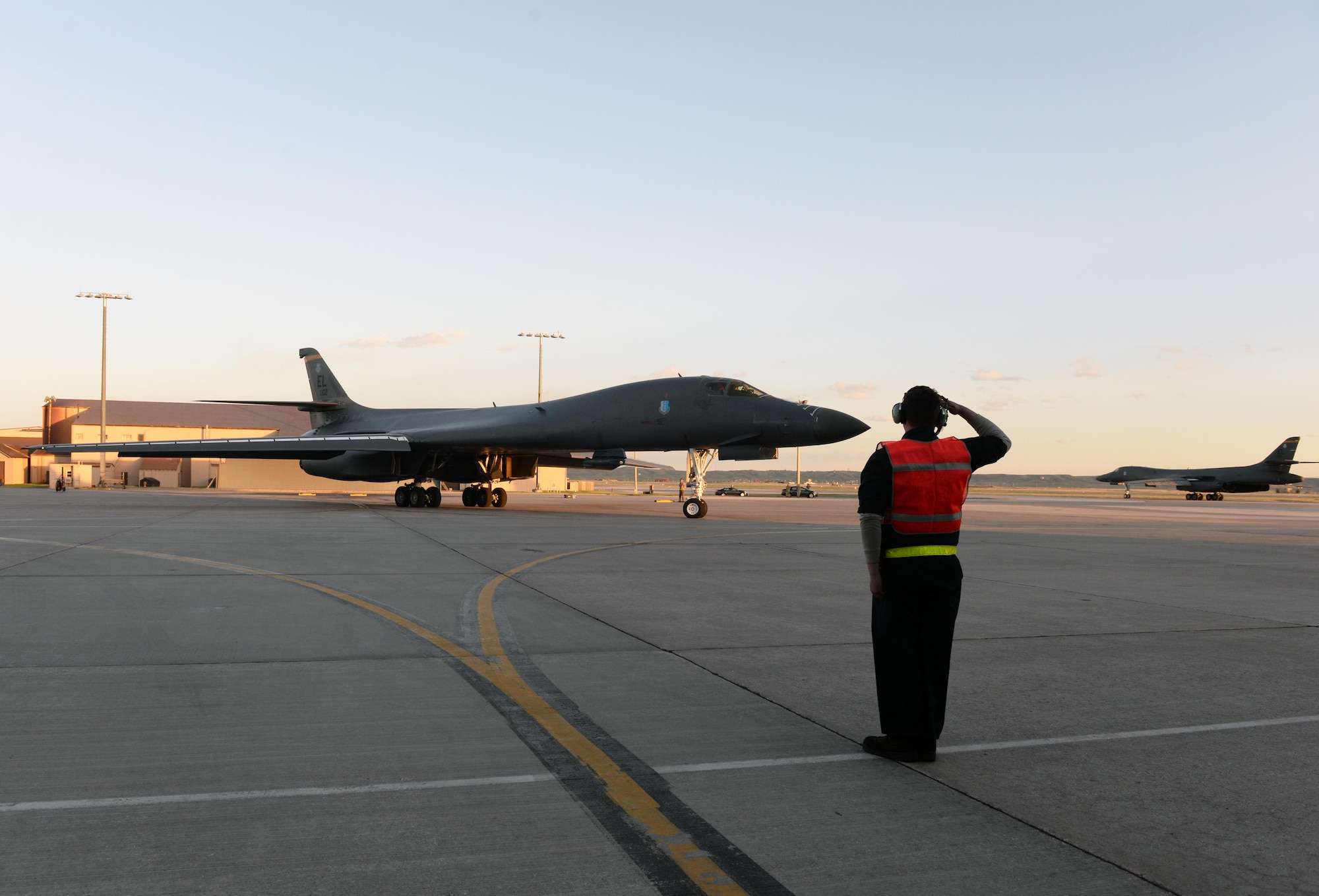 A maintainer salutes a B-1B Lancer assigned to the 28th Bomb Wing as it taxis to the runway to launch from Ellsworth Air Force Base, S.D., April 28, 2020. A pair of B-1s flew from the continental United States and conducted operations over the South China Sea as part of a joint U.S. Indo-Pacific Command and U.S. Strategic Command Bomber Task Force mission. (U.S. Air Force photo by Airman Quentin Marx)