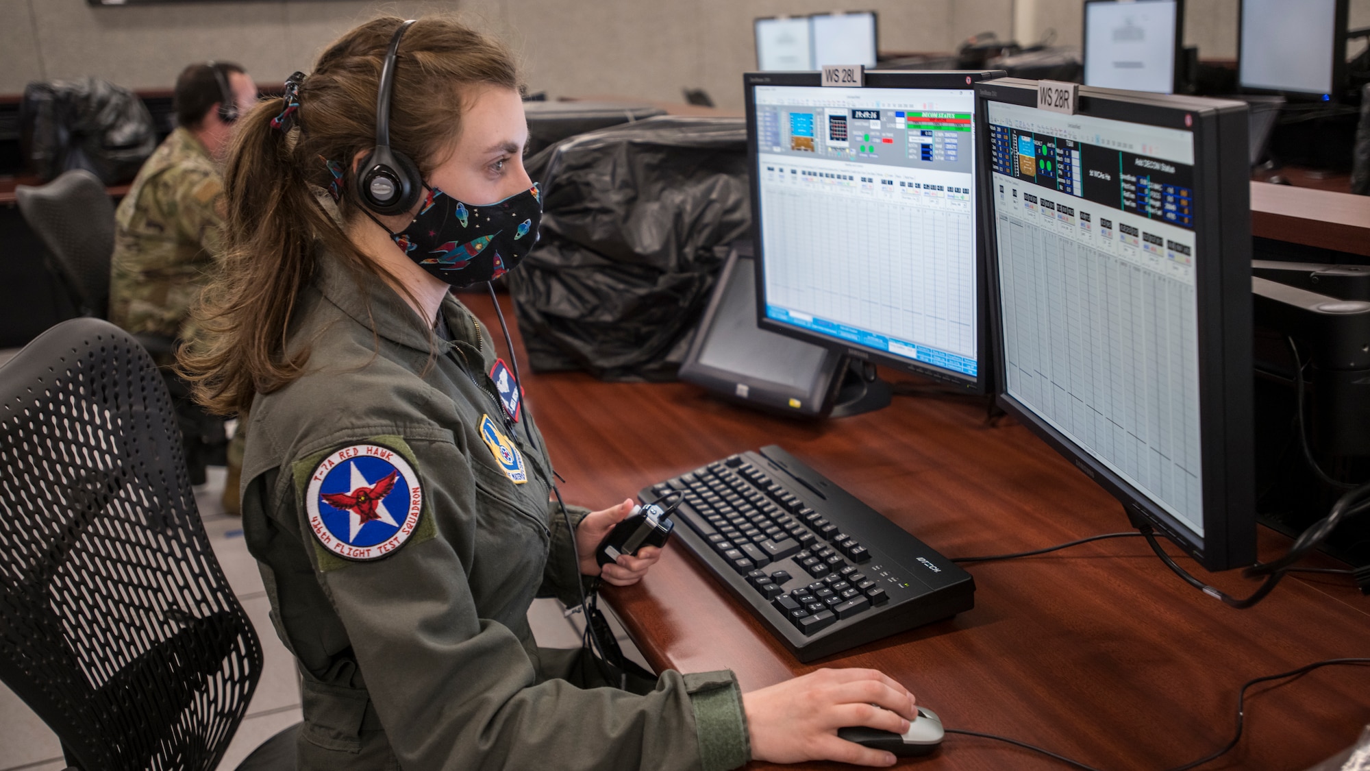 Rebecca Mitchell, T-7A Lead Flight Test Engineer, 416th Flight Test Squadron, watches real-time flight telemetry of a remote T-7A Red Hawk test flight from the Boeing flight test center in St. Louis, Missouri, at the Ridley Mission Control Center on Edwards Air Force Base, California, April 30. (Air Force photo by Giancarlo Casem)