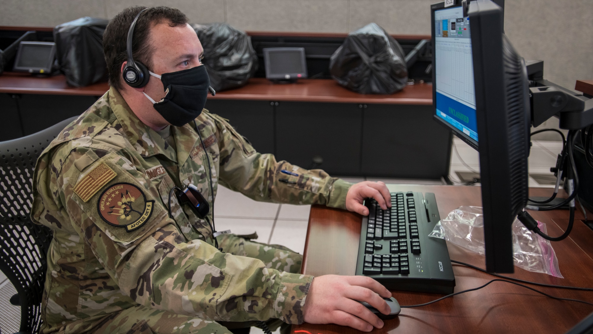 Master Sgt. Kyle Quigley, T-7A Operational Test Team Deputy Test Director, AFOTEC Det. 5, reviews flight data during a remote T-7A Red Hawk test flight from the Boeing flight test center in St. Louis, Missouri, at the Ridley Mission Control Center on Edwards Air Force Base, California, April 30. (Air Force photo by Giancarlo Casem)