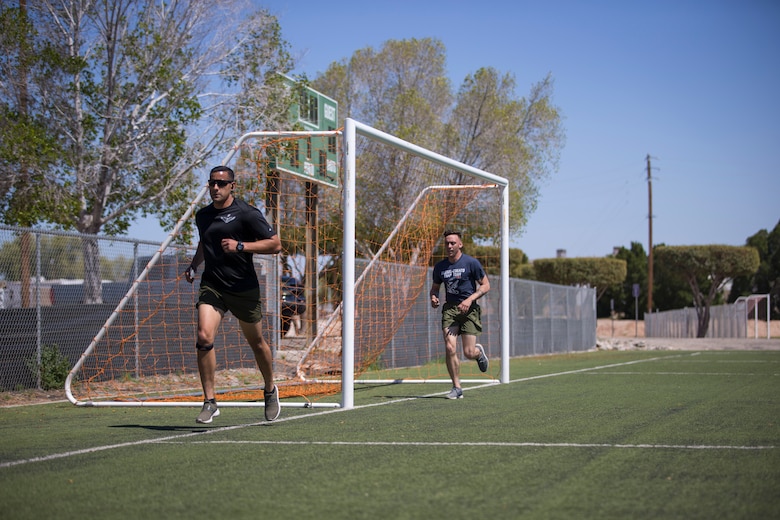 U.S. Marines with Marine Attack Squadron (VMA) 214, conduct physical training aboard Marine Corps Air Station (MCAS) Yuma, April 3, 2020. The training was conducted as part of their daily routine in preparation for the annual Physical Fitness Test. (U.S. Marine Corps photo by Lance Cpl John Hall)