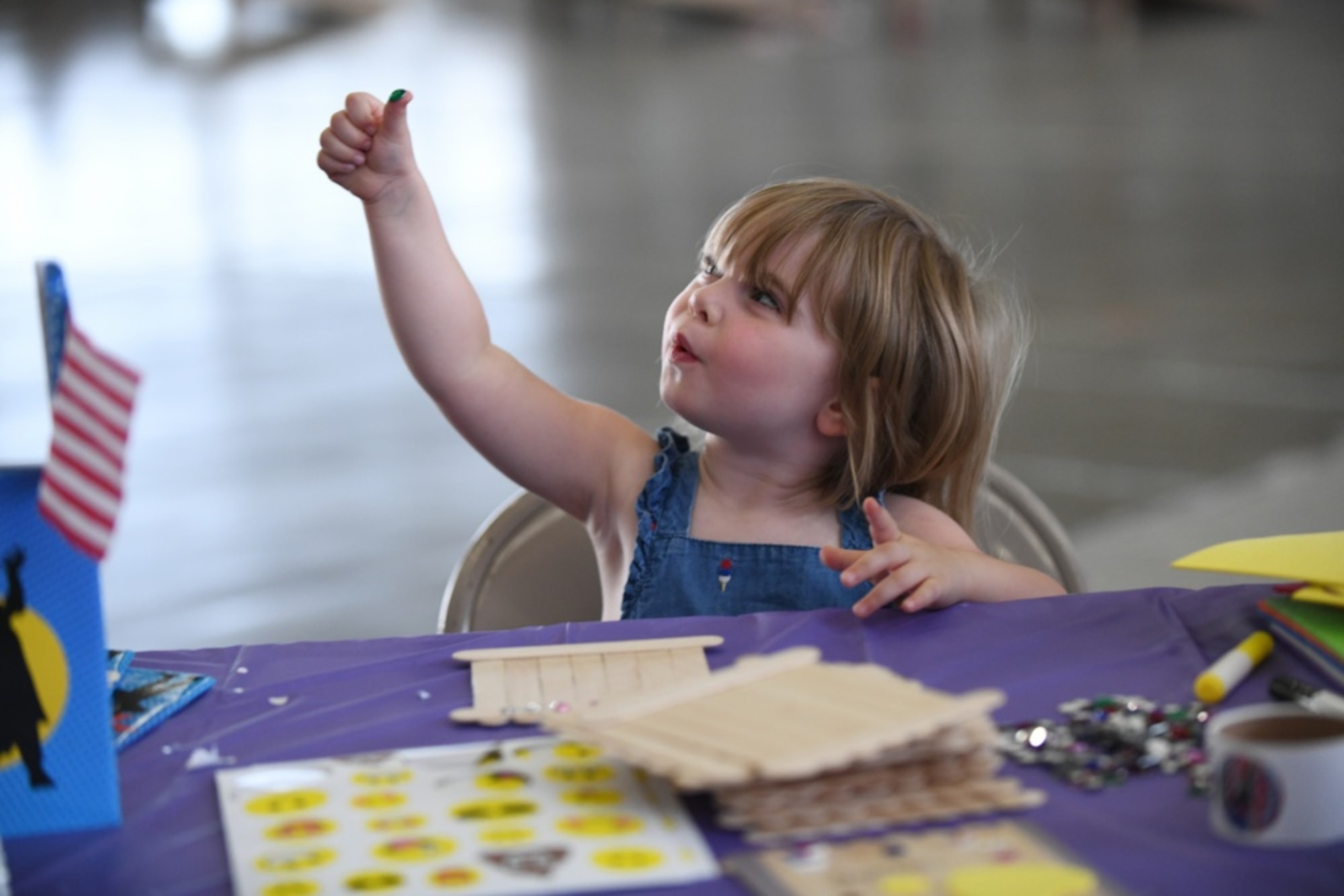 Shannon Cross, the daughter of Tech. Sgt. James Cross, a 34th Aircraft Maintenance Unit flight line expeditor, creates a picture frame at the arts and crafts table, during the Back to School Roundup held at the Pride Hangar on Ellsworth Air Force Base, S.D., Aug. 18, 2019. April has been designated as the Month of the Military Child. It is set aside to honor the strength and sacrifices of military children across all branches. (U.S. Air Force photo by Airman 1st Class Christina Bennett)