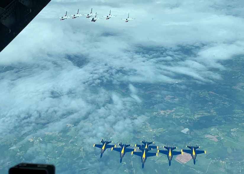 A photo of U.S. Navy Blue Angels and U.S. Air Force Thunderbirds flying together.