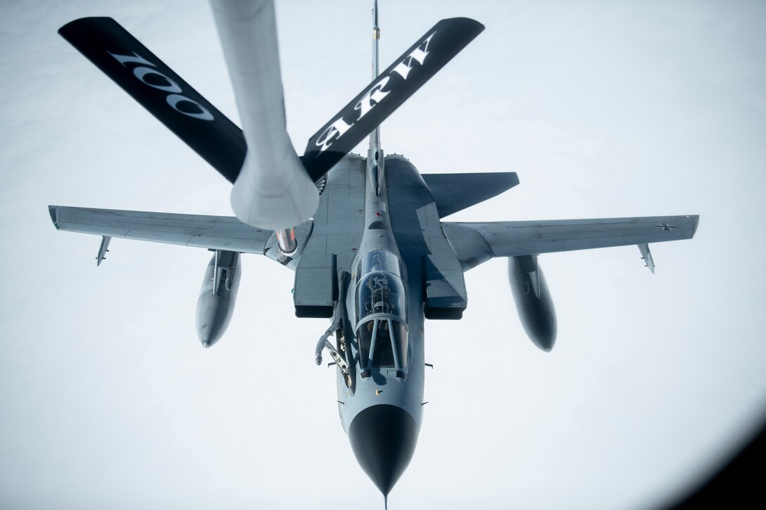 Fighter jet being refueled.