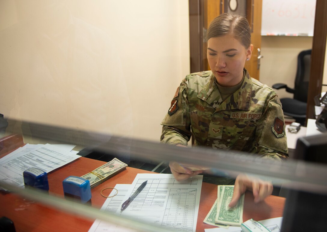 U.S. Air Force Airman 1st Class Caroline Mixon, 39th Comptroller Squadron financial technician, counts money behind the cash cage at Incirlik Air Base, Turkey, April 22, 2020.
