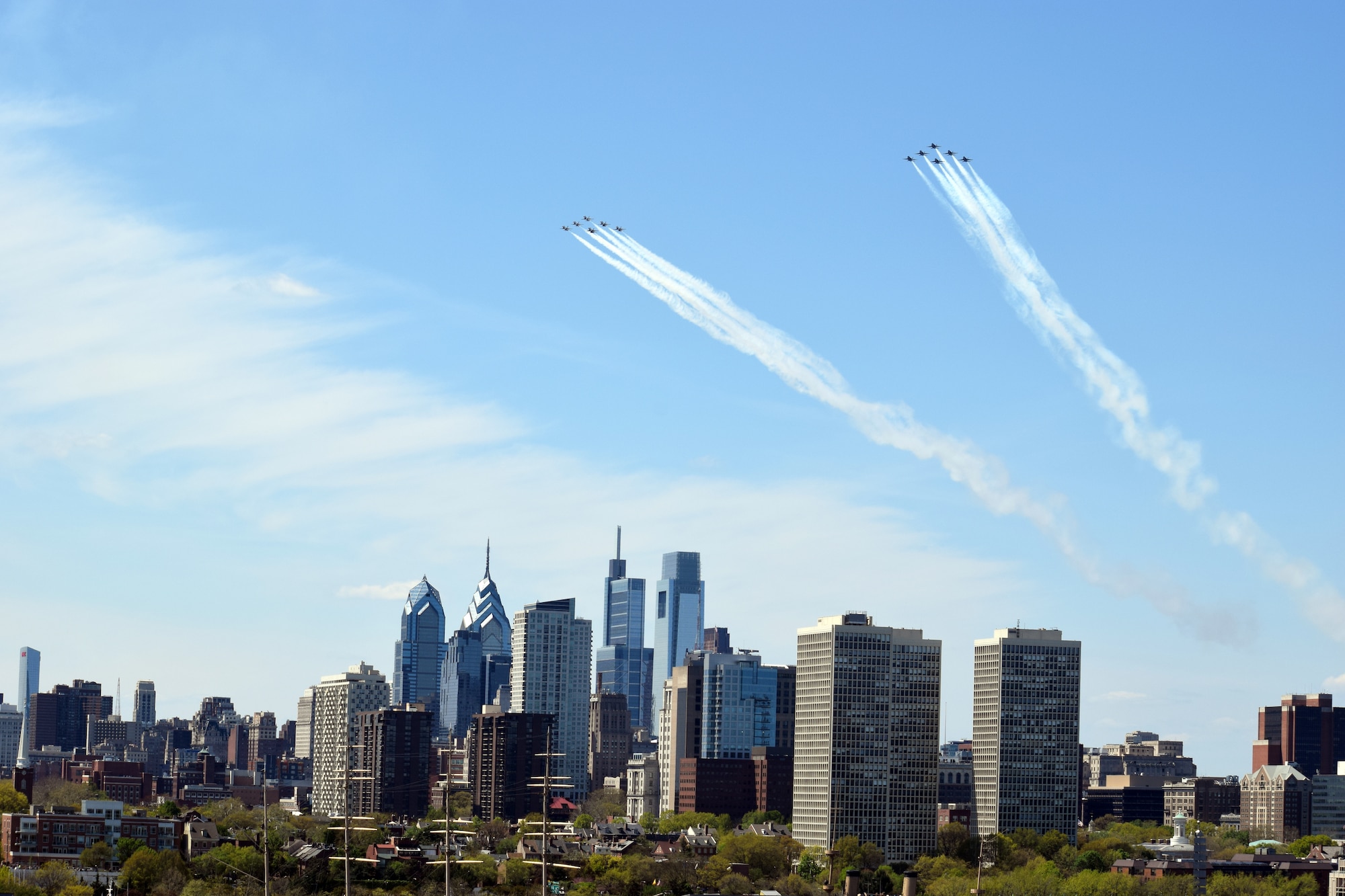 The U.S. Air Force Thunderbirds and the U.S. Navy Blue Angels fly over Philadelphia during an America Strong flyover, April 28, 2020. The demonstration teams conducted flyovers in areas of New York, New Jersey and Pennsylvania to honor healthcare workers, first responders, and other essential personnel who are working on the front lines to combat COVID-19. (U.S. Air Force photo by Maj. Brian Wagner)