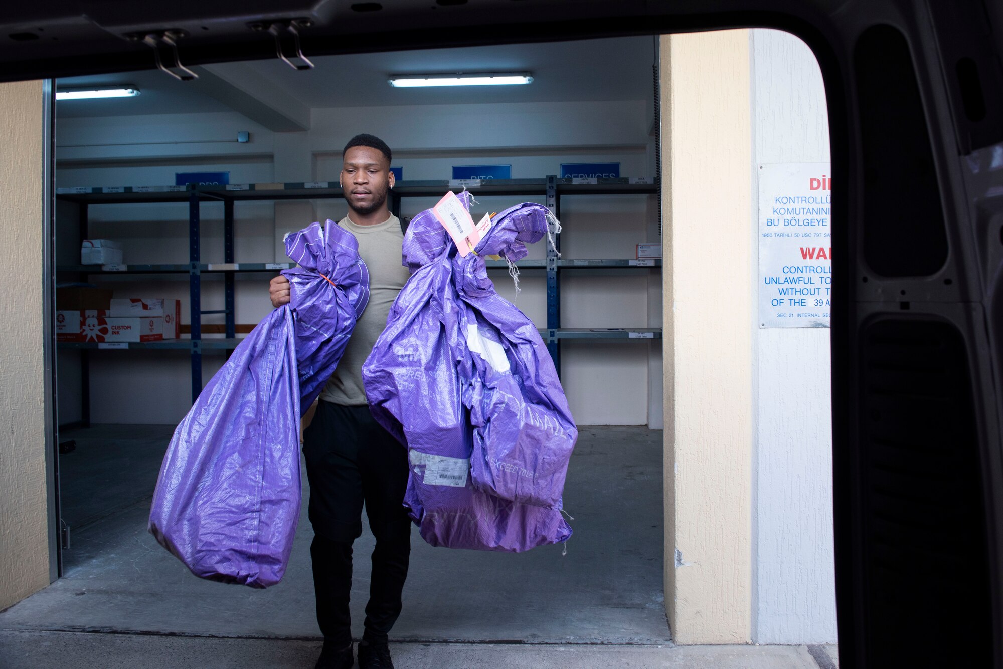U.S. Air Force Airman 1st Class McArthur Terrell, 39th Force Support Squadron postal clerk, loads packages onto a van April 28, 2020, at Incirlik Air Base, Turkey. Besides serving U.S. troops at Incirlik, the 39th FSS post office also forwards mail to troops stationed in other parts of Turkey. (U.S. Air Force photo by Staff Sgt. Joshua Magbanua)