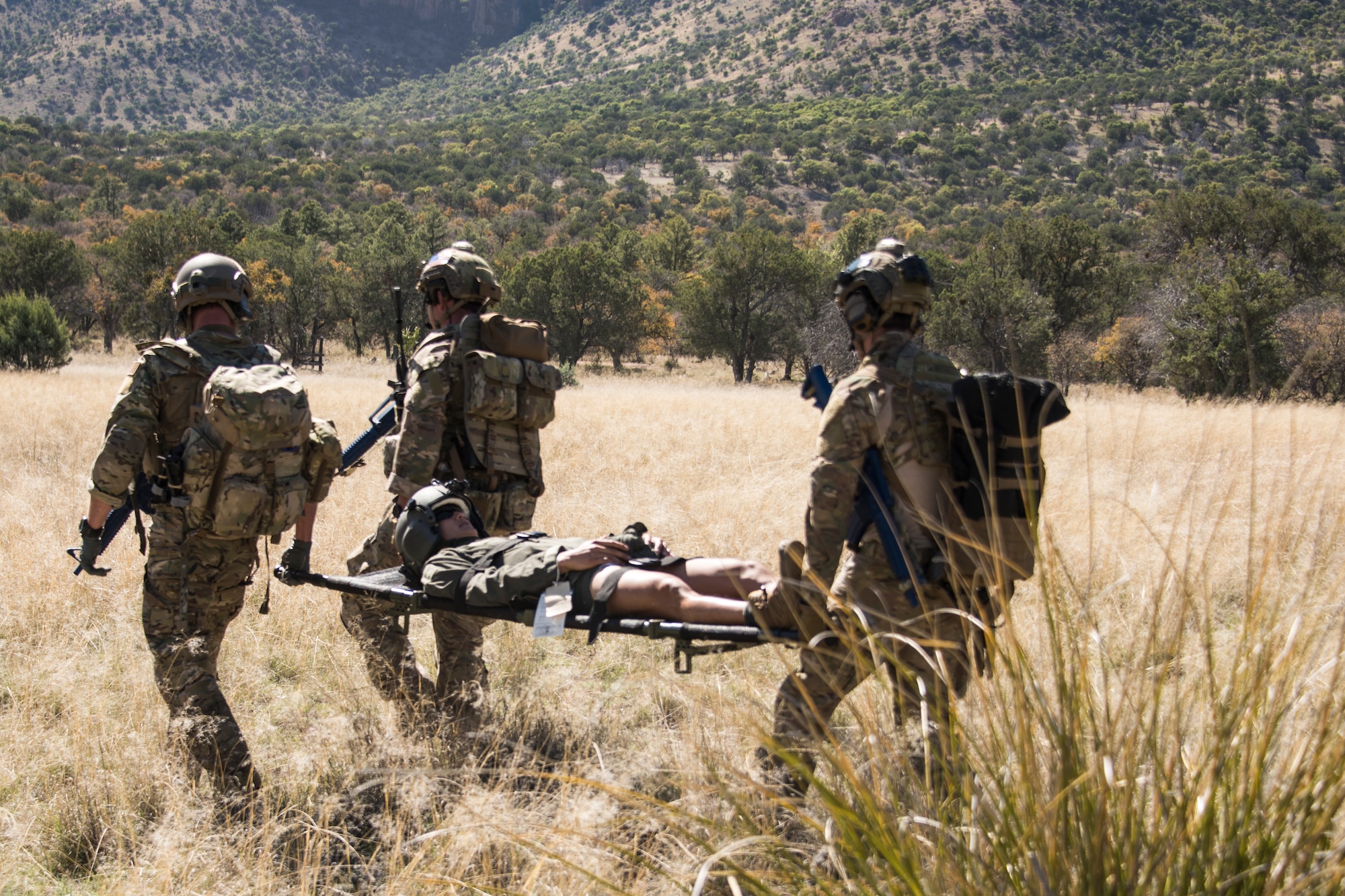 A photo of pararescueman carrying a simulated isolated personnel