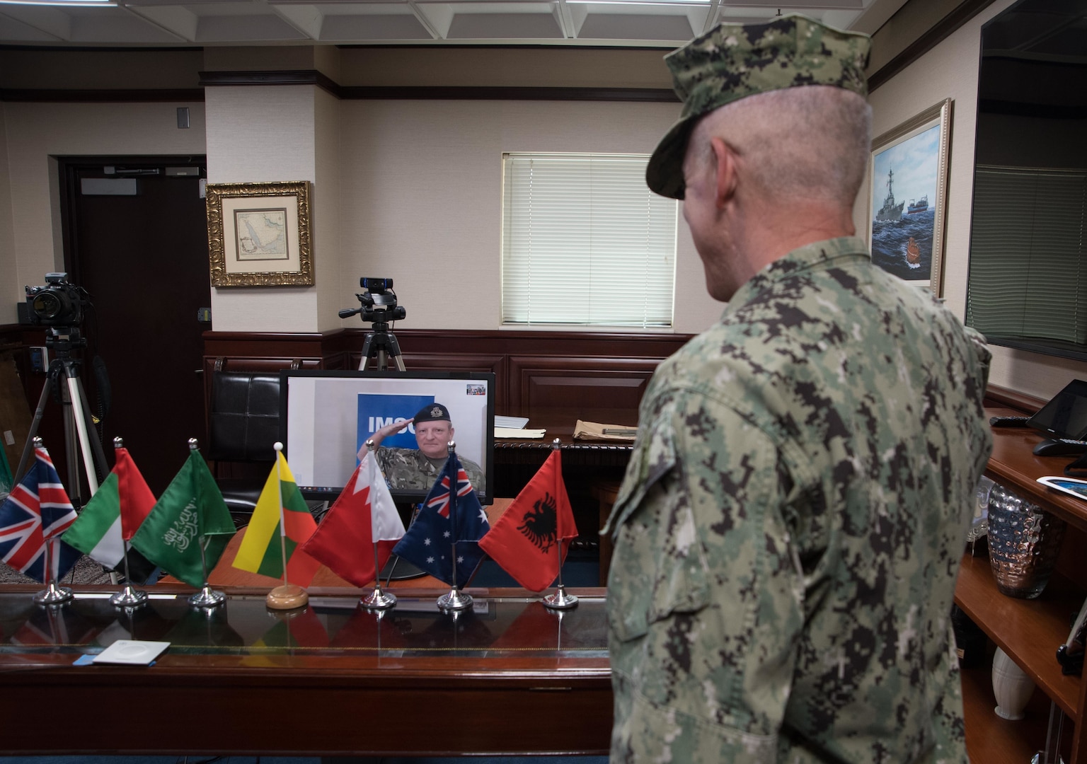 200430-N-KZ419-1055 NAVAL SUPPORT ACTIVITY BAHRAIN, Bahrain (April 30, 2020) Vice Adm. Jim Malloy, right, commander of U.S. Naval Forces Central Command and Combined Maritime Forces salutes Royal Navy Commodore Robert Bellfield as he assumes command during a virtual change of command for the International Maritime Security Construct (IMSC). IMSC maintains the freedom of navigation, international law, and free flow of commerce to support regional stability and security of the maritime commons. (U.S. Navy photo by Mass Communication Specialist 3rd Class Dawson Roth)