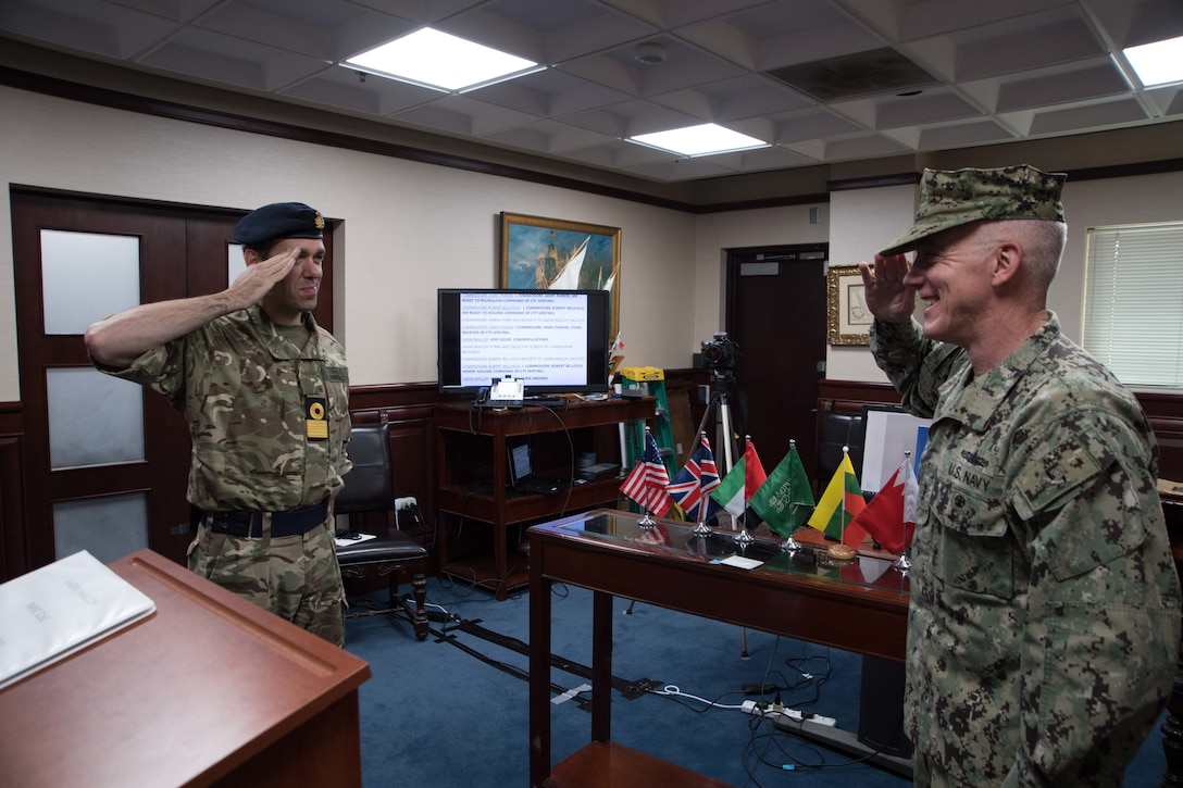 200430-N-KZ419-1045 NAVAL SUPPORT ACTIVITY BAHRAIN, Bahrain (April 30, 2020) Vice Adm. Jim Malloy, right, commander of U.S. Naval Forces Central Command and Combined Maritime Forces salutes Royal Navy Commodore James Parkin during a virtual change of command for the International Maritime Security Construct (IMSC). IMSC maintains the freedom of navigation, international law, and free flow of commerce to support regional stability and security of the maritime commons. (U.S. Navy photo by Mass Communication Specialist 3rd Class Dawson Roth)