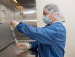 Michelle Mendoza, pharmacy technician, reconstitutes the remdesivir research drug under an intravenous hood at Brooke Army Medical Center, Fort Sam Houston, Texas, April 29, 2020. BAMC is participating in a COVID-19 treatment trial centering on the anti-viral drug, remdesivir. The National Institute of Allergy and Infectious Diseases (NIAID)-sponsored study has enrolled hundreds of people across the nation as it looks to determine if the antiviral drug is effective against COVID-19. (U.S. Army photo by Jason W. Edwards)