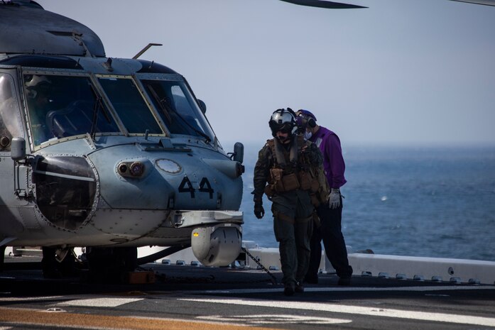 A U.S. Navy MH-60 Seahawk pilot returns to the amphibious assault ship USS Makin Island during ongoing search and rescue operations following an AAV-P7/A1 assault amphibious vehicle mishap off the coast of Southern California, July 30, 2020. Assisting in the search and rescue operations are the guided-missile destroyer USS John Finn, multiple U.S. Navy MH-60 helicopters and small boats from USS Makin Island, the amphibious transport dock USS Somerset, the amphibious transport dock USS San Diego, as well as the U.S. Coast Guard Cutter Forrest Rednour and a Coast Guard MH-60 Jayhawk helicopter from Coast Guard Sector San Diego.