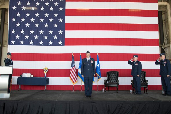 Maj. Gen. John Healy, 22nd Air Force commander, stands center stage while members of the 302nd Airlift Wing salute him.