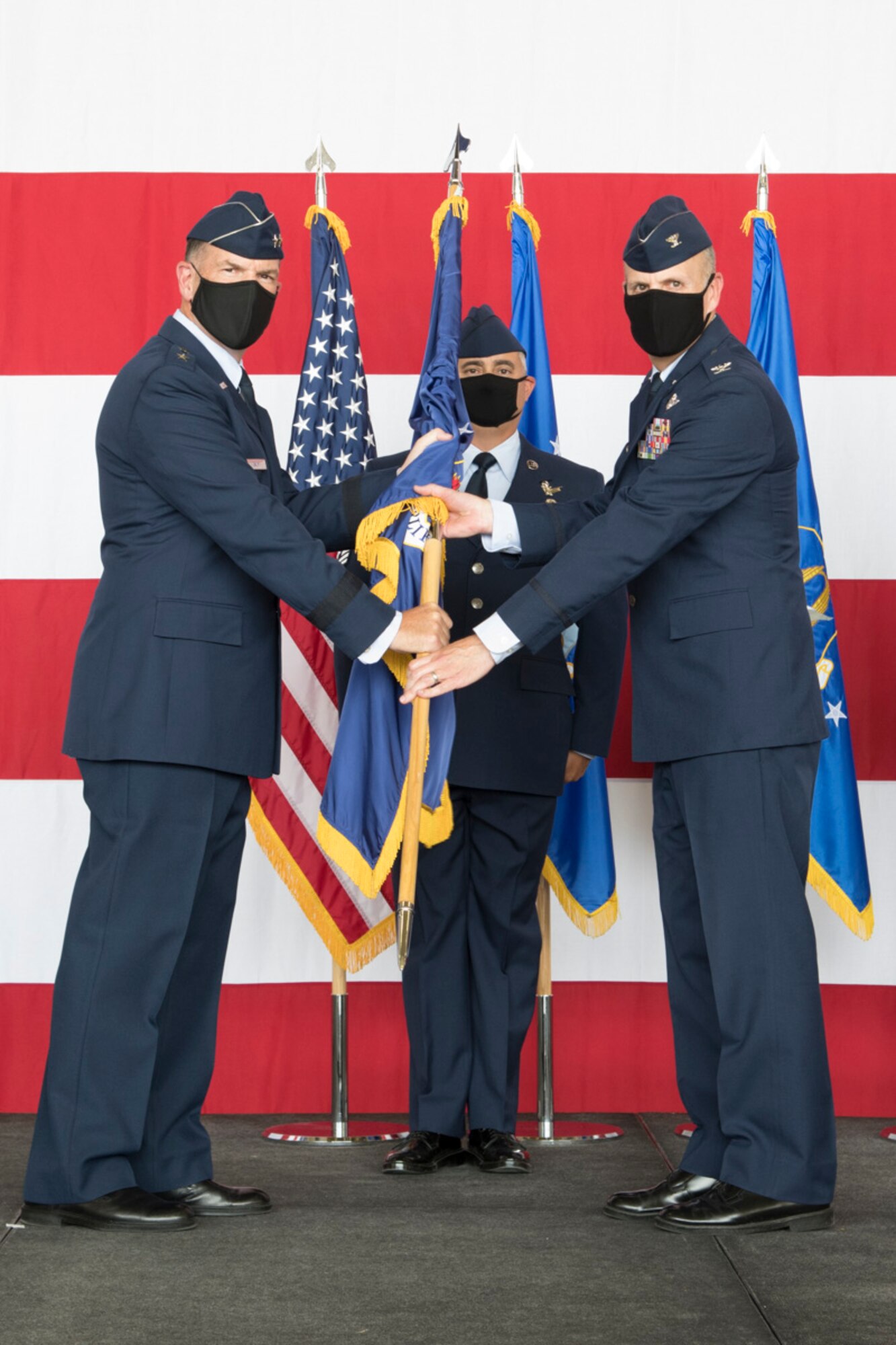 Maj. Gen. John Healy, 22nd Air Force commander, passes the 302nd Airlift Wing guidon to Col. Christopher Zidek as the new commander during the 302 AW change of command ceremony.
