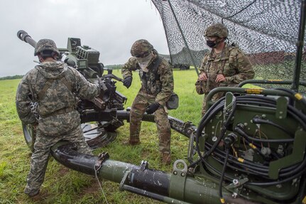 Soldiers from Battery B, 1st Battalion, 160th Field Artillery Regiment, 45th Infantry Brigade Combat Team, conduct a mock fire mission during crew drill training at their home armory in Holdenville, Oklahoma, July 29, 2020. The Soldiers, along with other units of the 45th IBCT, are taking part in home-station annual training with limited field training exercises while implementing COVID-19 countermeasures like social distancing or wearing masks.