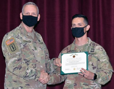 Maj. Gen. Dennis LeMaster, U.S. Army Medical Center of Excellence commander, presents Staff Sgt. Travis Webster an award