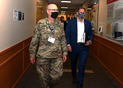 Lt. Col. Woody Groton, exercise director of Cyber Yankee 2020, leads N.H. Gov. Chris Sununu on a tour of the event on July 31, 2020, at the Edward Cross Training Center in Pembroke, N.H.