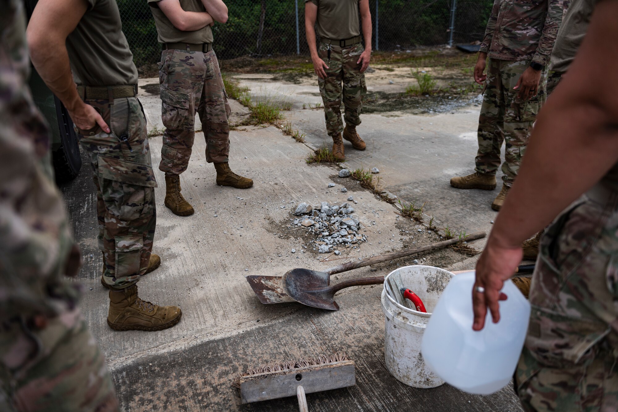 A photo of Airmen surrounding a spall.