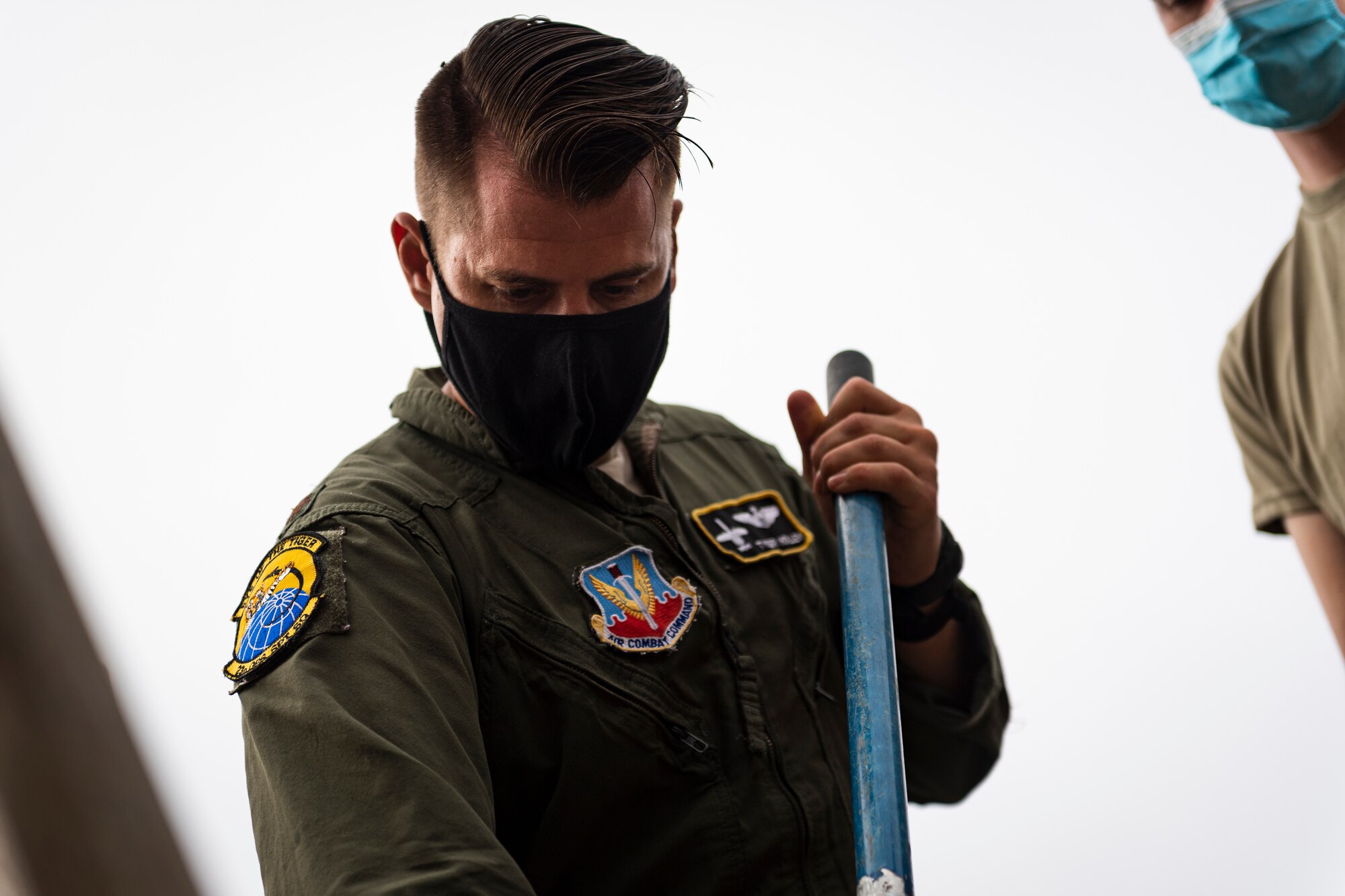A photo of an Airman mixing concrete.