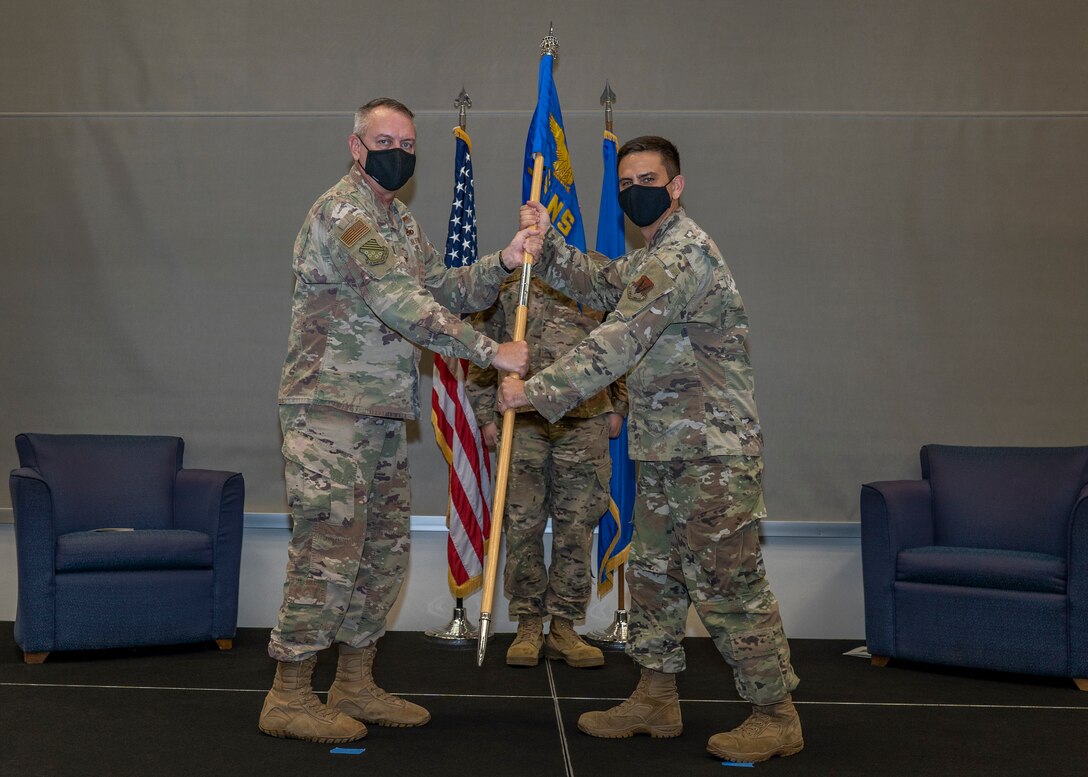 United States Air Force Maj. Michael Lundy (right) assumes command of the 1st Munitions Squadron during the units official reactivation and assumption of command ceremony officiated by Col. David Seitz, 1st Maintenance Group commander, July 31, 2020 at Joint Base Langley-Eustis, Virginia. Lundy transitions from the 94th Fighter Squadron where he served as the director of maintenance. (US. Air Force photo by Nicholas J. De La Pena)