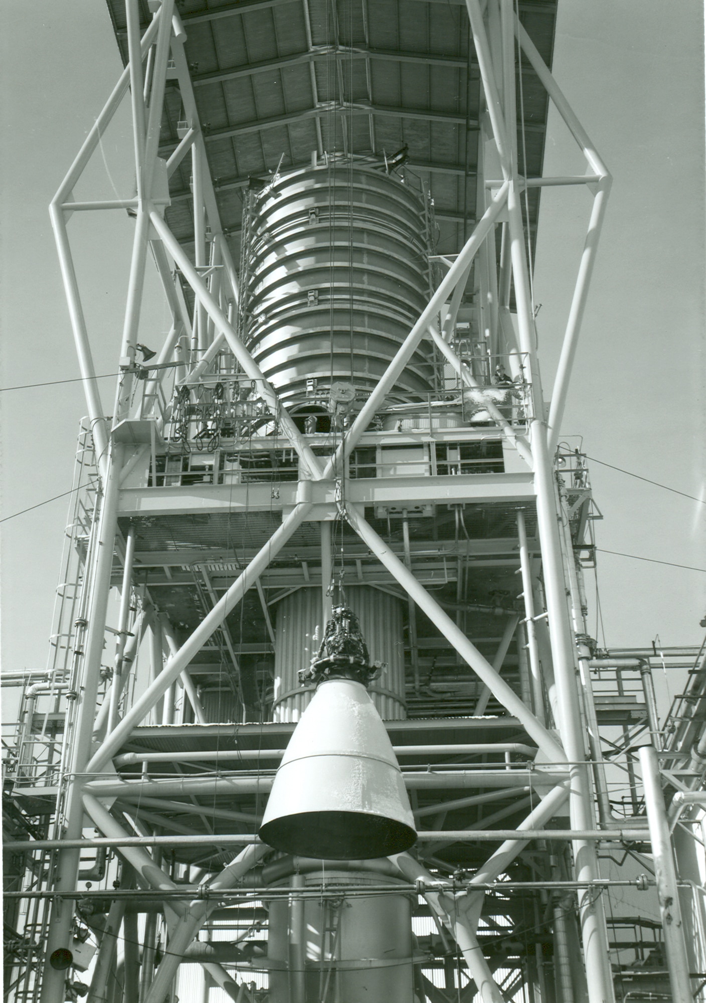 The rocket motor for the Apollo Service Module is installed for testing in J-3 at Arnold Air Force Base in 1966. The motor was repeatedly test fired in near space conditions to help NASA qualify the system as man-rated for the flight to the moon. This year marks the 60th anniversary of completion of the construction on J-3 and the initiation of the first operational test in the cell. (U.S. Air Force photo)