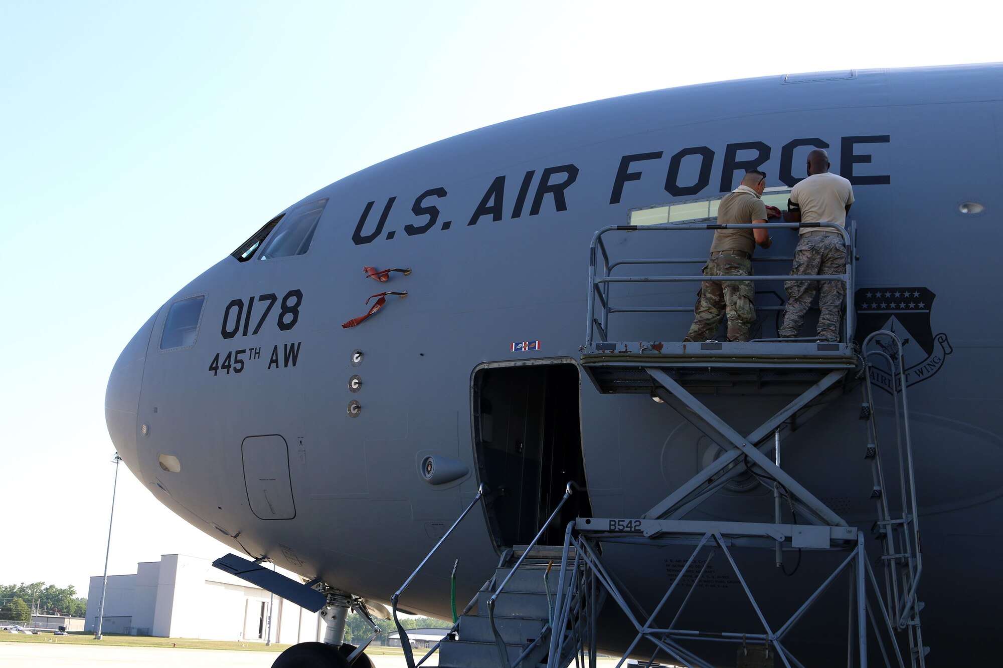 Master Sgt. Toron Franklin, aircraft mechanic and crew chief with the 445th Maintenance Group, installs a new electroluminescent panel on the Wright Patterson Air Force Base, Ohio, flightline, July 19, 2020. The electroluminescent panel glows green when in use. When connected to an alternating current/direct current source, this panel emanates light from crystalline powders or phosphors that are sandwiched between electrically conductive surfaces, one of which is translucent. The powders absorb the electrical energy and convert it instantly into light with minimal heat. (U.S. Air Force photo/Senior Airman Amelia Burnett)