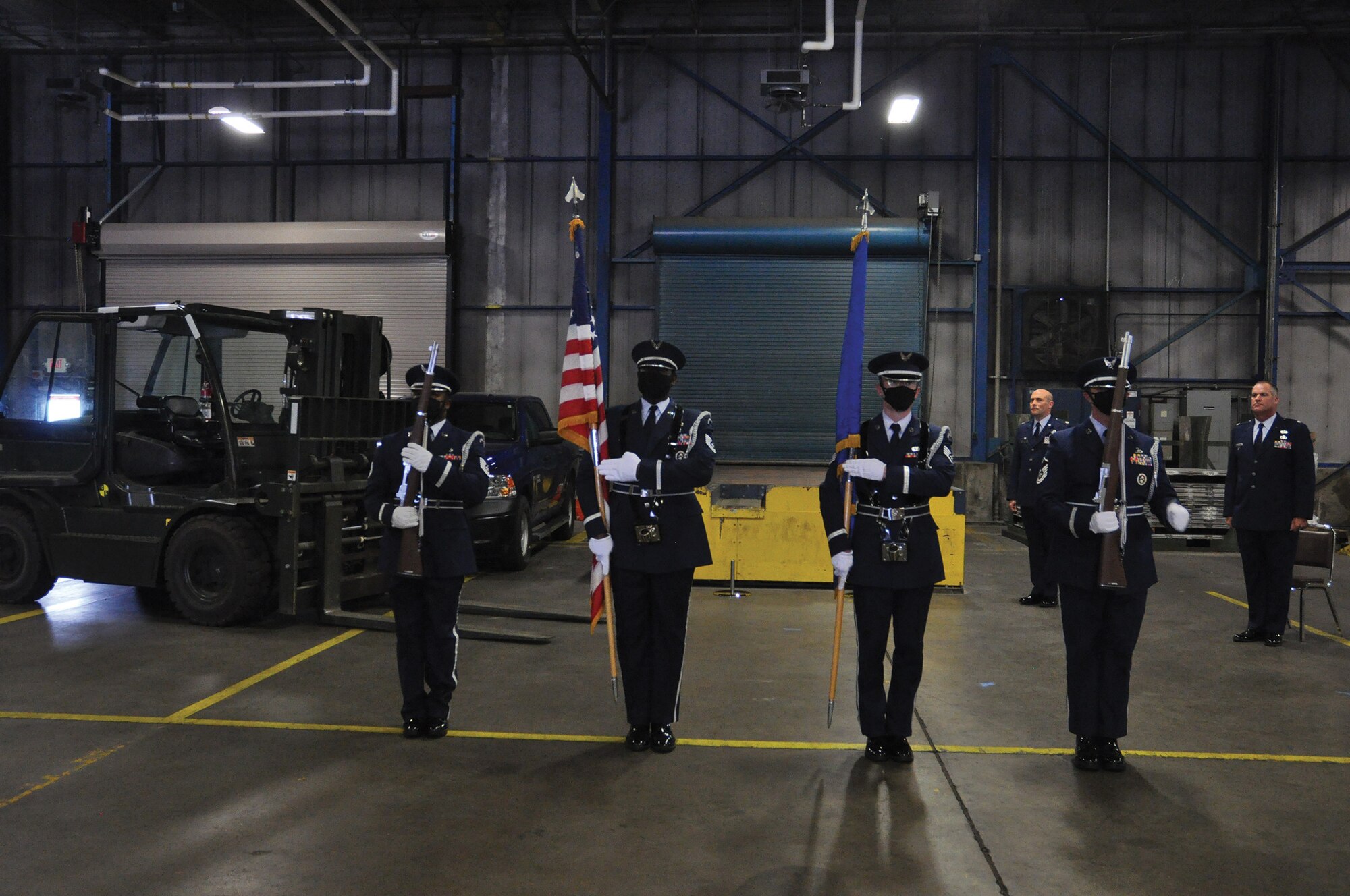 445th Airlift Wing Honor Guard members posts the Colors at the 87th Aerial Port Squadron Change of Command July 11, 2020 at Wright-Patterson Air Force Base. Being a member of the honor guard requires commitment, responsibility and a strong sense of purpose. It also requires a face mask mandated as one of the safety precautions due to COVID-19. Honor guard resumed attending official wing functions at the beginning July. (U.S. Air Force photo/Senior Airman Angela Jackson)