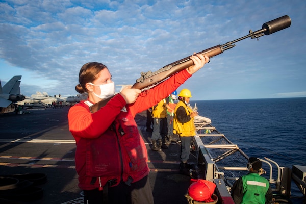 Gunner's Mate 3rd Class Corrin Abellar, from Kansas City, Kansas, shoots a line during a fueling-at-sea aboard the Nimitz-class aircraft carrier USS Dwight D. Eisenhower (CVN 69).