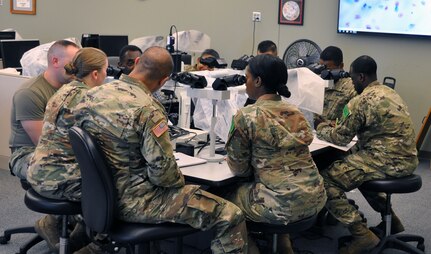 Students in the Medical Education and Training Campus cytotechnologist program participate in an instructor-led microscopic workshop and discussion of atypical cell criteria.