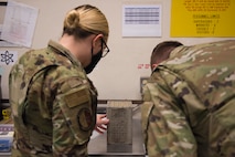 Airman 1st Class Cassie Crisp (left), a conventional maintenance crew chief, and Airman 1st Class Cory Klingener, a conventional maintenance crew member, both assigned to the 437th Maintenance Squadron, replace flares in a flare set, July 20, 2020, at Joint Base Charleston, S.C. The flares are used on aircraft in order to attempt to divert attention when the aircraft is believed to be in danger. This is just one task the munitions flight has to perform, other tasks include flightline support, base support, and NASA and SpaceX support.