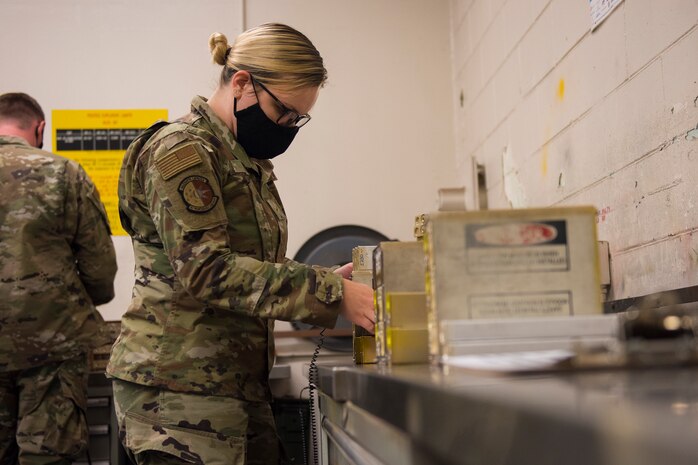 Airman 1st Class Cassie Crisp, a conventional maintenance crew chief assigned to the 437th Maintenance Squadron, replaces flares in a flare set, July 20, 2020, at Joint Base Charleston, S.C. The flares are used on aircraft in order to attempt to divert attention when the aircraft is believed to be in danger. This is just one task the munitions flight has to perform, other tasks include flightline support, base support, and NASA and SpaceX support.