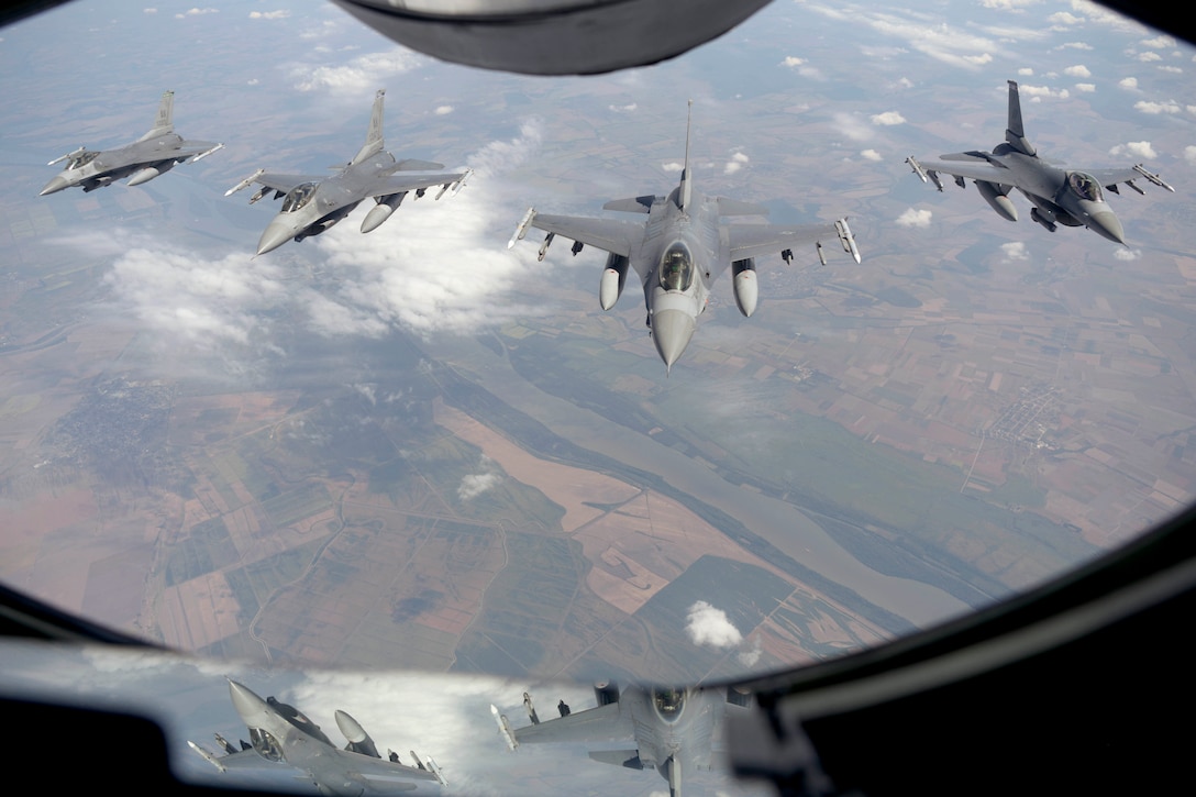 Four aircraft fly in formation.