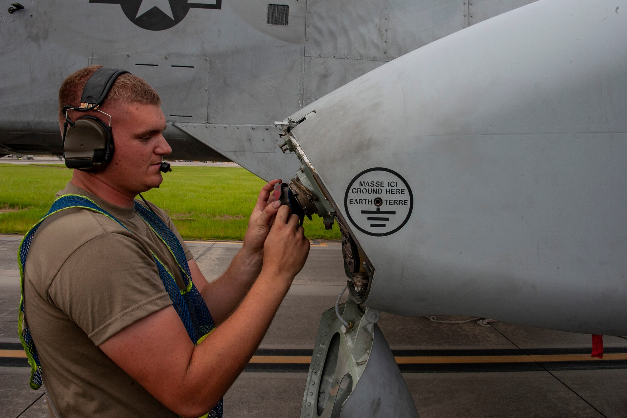 A photo of an Airmen putting tapes into an aircraft.
