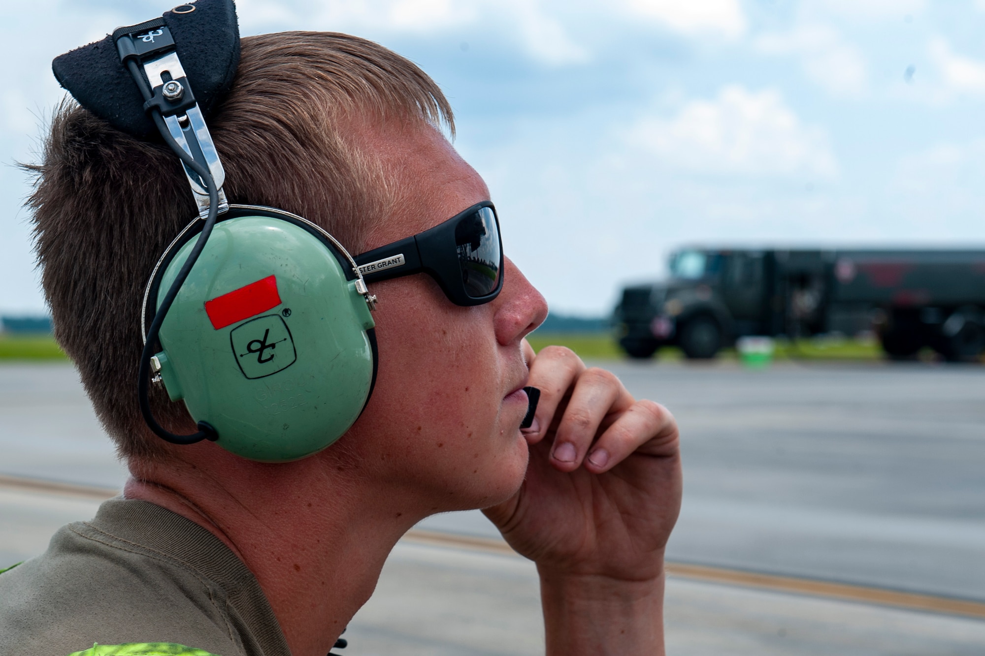 A photo of an Airman talking on a headset.