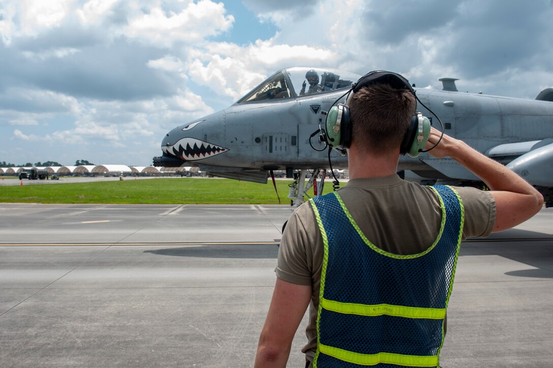 A photo of an Airman saluting a pilot.