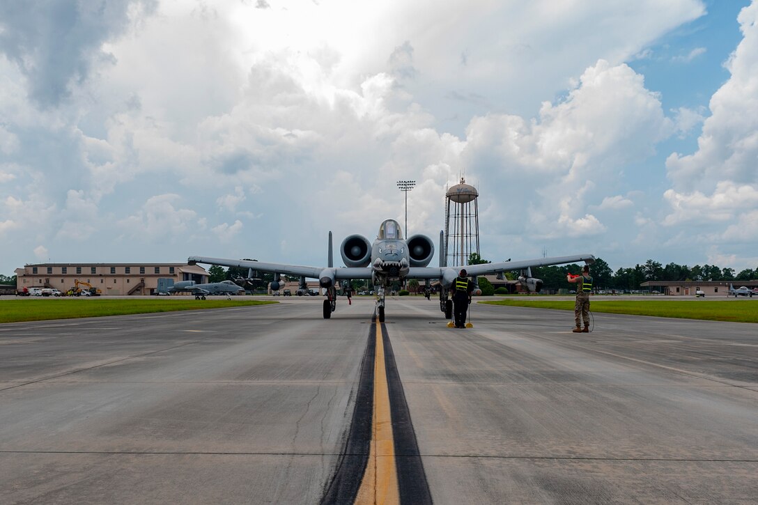 A photo of Airman guiding a plane.