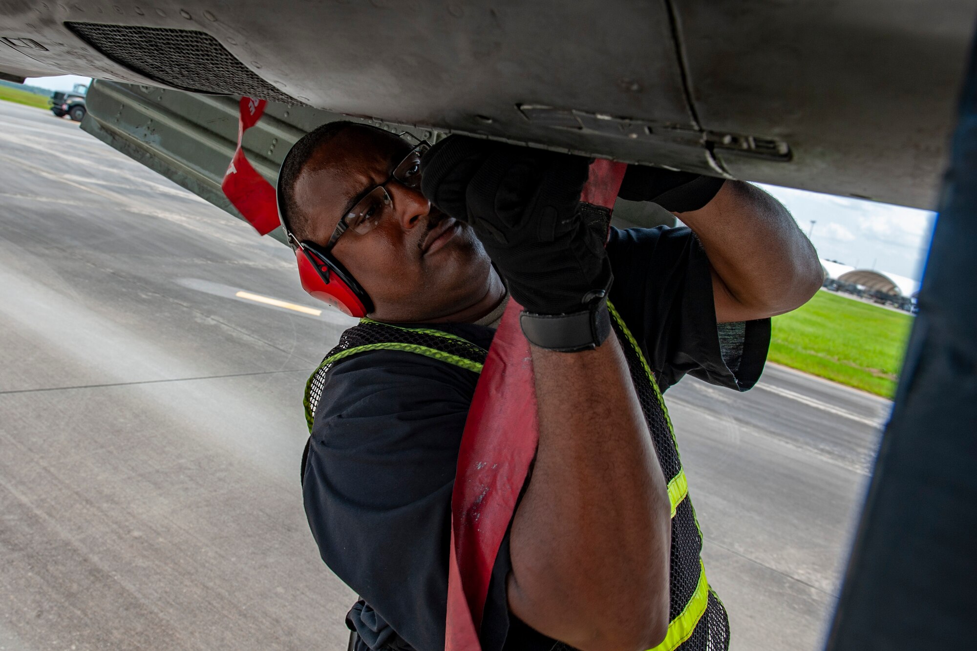 A photo of an Airman placing tags on a plane.
