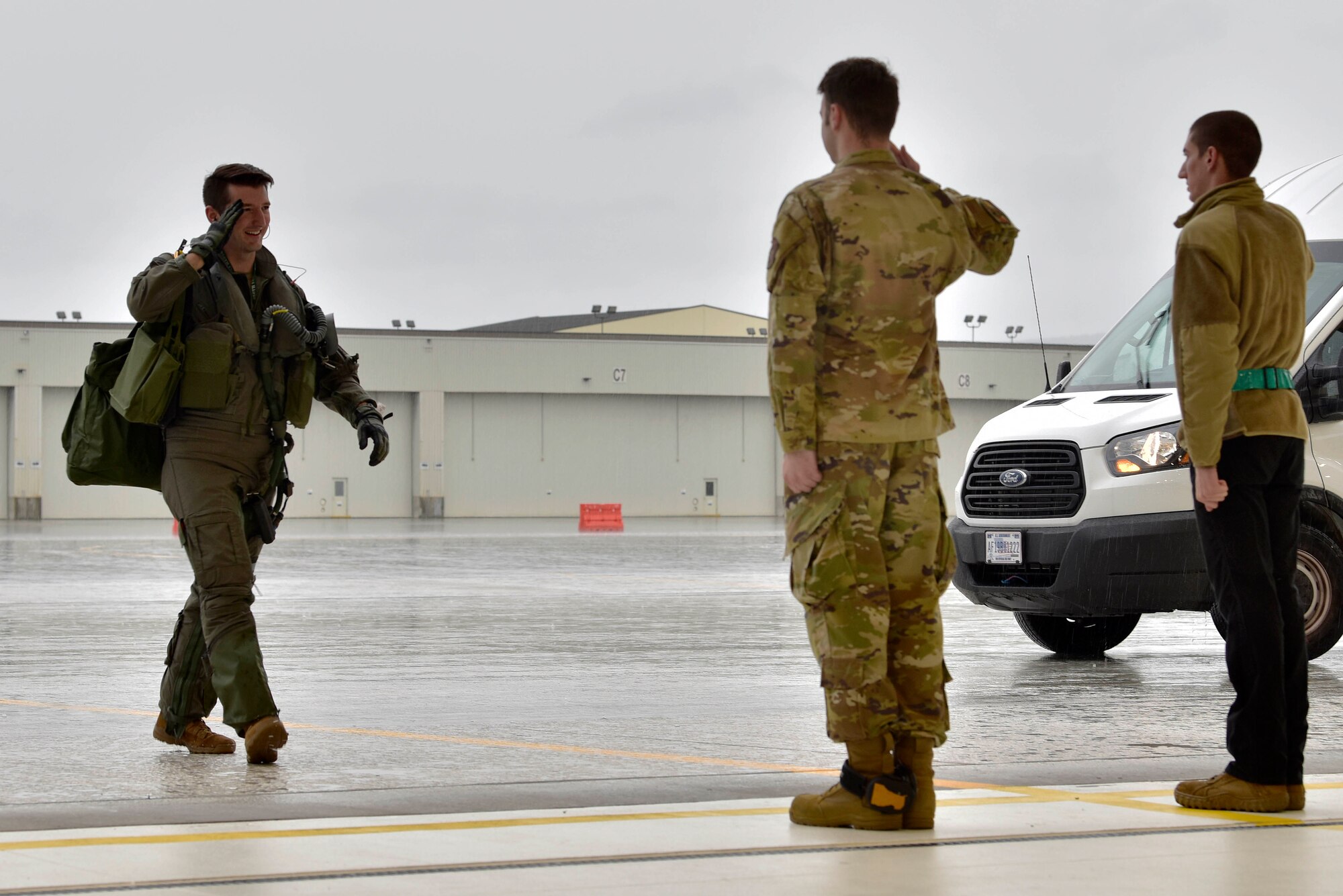 U.S. Air Force Airmen 1st Class Devin Duhon, a 354th Aircraft Maintenance Squadron F-35A Lightning II crew chief, and Cody Frazier, a 354th AMXS avionics journeyman, render a salute to Maj. Jonathan Bucey, a 356th Fighter Squadron F-35 pilot, during RED FLAG-Alaska 20-3 on Eielson Air Force Base, Alaska, Aug. 3, 2020. The 354th Maintenance Group provides aircraft and munitions maintenance support to the 354th Fighter Wing's F-35A Lightning II and F-16 Fighting Falcons. (U.S. Air Force photo by Senior Airman Beaux Hebert)