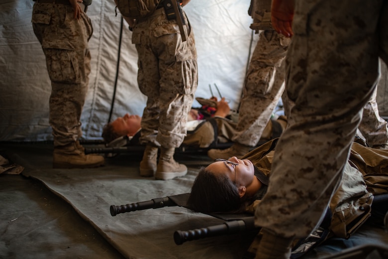 U.S. Navy Corpsmen with 1st Medical Battalion, 1st Marine Logistics Group, prepare patients to be sent to the next echelon of care during Exercise Four Horsemen on Camp Pendleton, California, 16 July, 2020. The purpose of this exercise is to assess mission and logistical readiness. The Mission of 1st Medical Battalion is to provide health service support to the operational units of the I Marine Expeditionary Force (I MEF). (U.S. Marine Corps photo by Sgt. Kyle McNan)