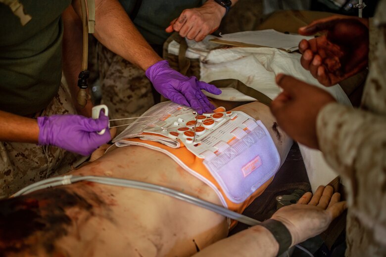 U.S. Navy Corpsmen with 1st Medical Battalion, 1st Marine Logistics Group, provide medical attention to a training dummy during Exercise Four Horsemen on Camp Pendleton, California, 16 July, 2020. The purpose of this exercise is to assess mission and logistical readiness. The Mission of 1st Medical Battalion is to provide health service support to the operational units of the I Marine Expeditionary Force (I MEF).   (U.S. Marine Corps photo by Sgt. Kyle McNan)