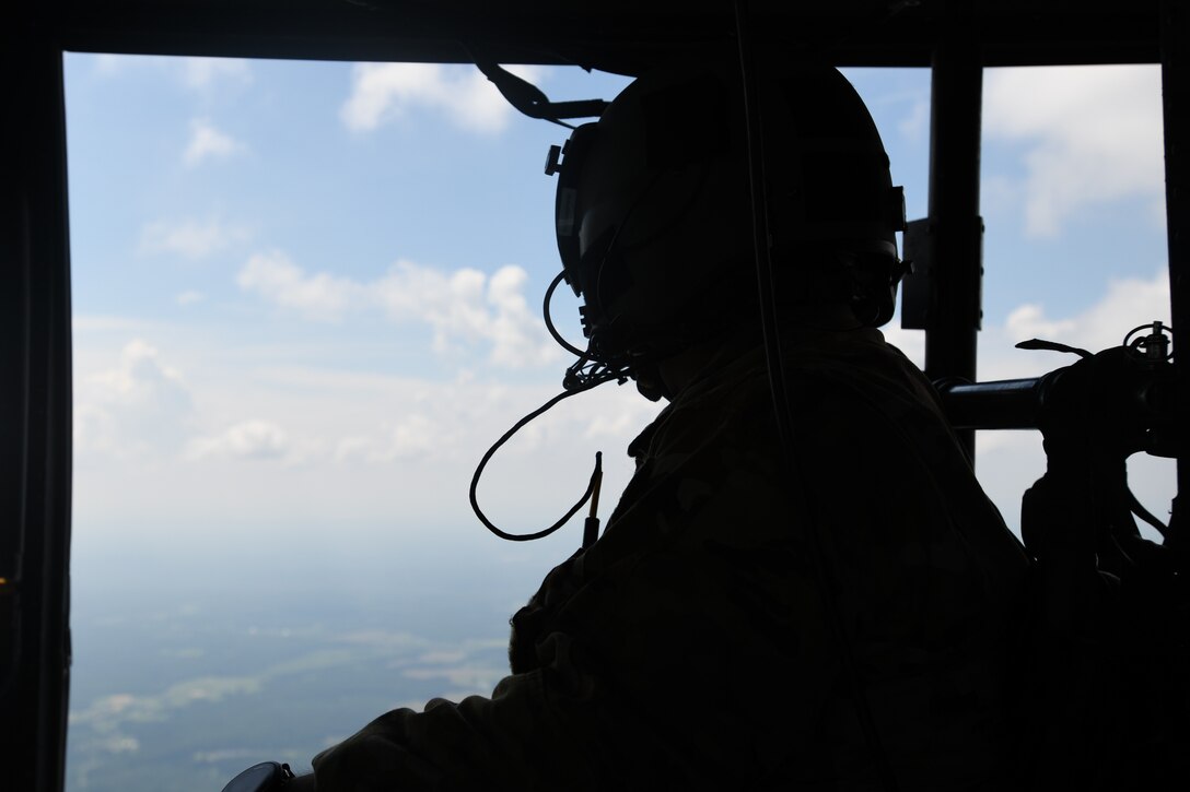 Staff Sgt. Adrian Acasio, 1st Helicopter Squadron special missions aviator, looks toward the view during a training flight with the 1st HS, July 30, 2020.