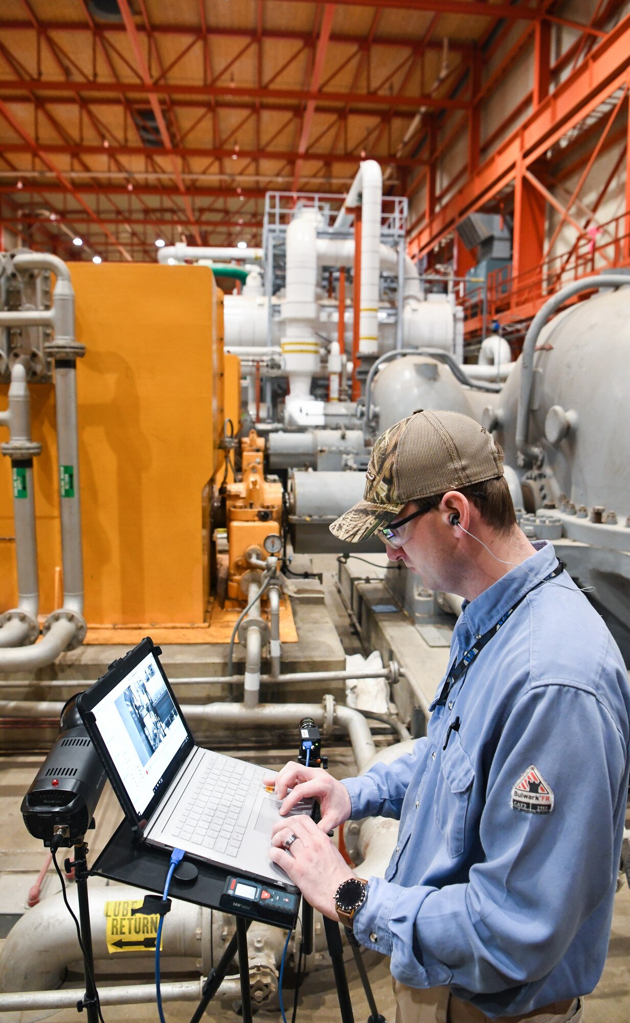 Landon Culver, an Arnold Engineering Development Complex Condition-Based Maintenance craftsman, sets up a Motion Amplification Camera, March 4, 2020, to help identify the source of excessive vibrations in machinery in the C Plant of the Engine Test Facility at Arnold Air Force Base, Tenn. (U.S. Air Force photo by Jill Pickett)